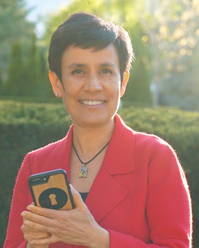 Photo of ILONA POSNER UX Consultant Holding phone with keyhole icon on it.